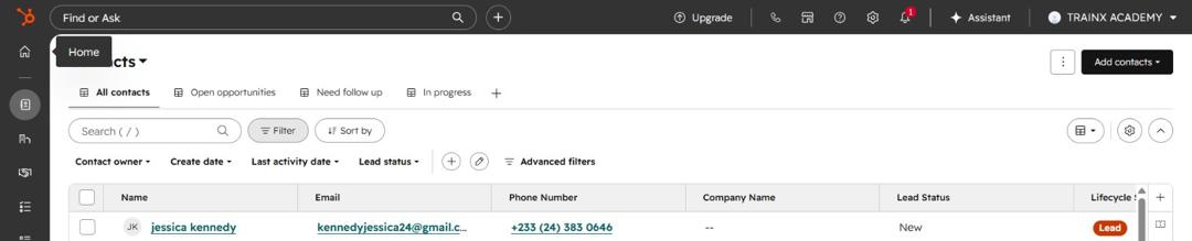 HubSpot CRM contacts list showing a lead with name, email, phone number and lead status.